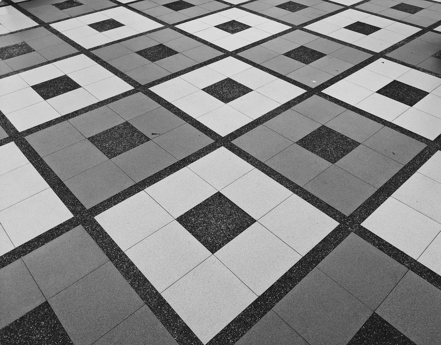 Grey geometric tiled floor pattern.